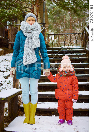Young mother plays with her baby on a winter day Young mother plays with her baby on a winter day 72070461