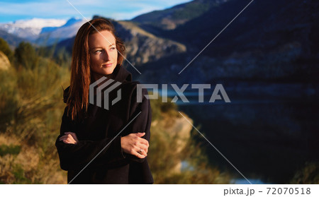 Woman posing on mountainous background 72070518