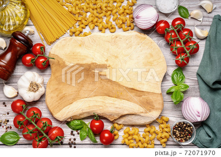 Top view of empty wooden board with vegetables around Top view of empty wooden board with vegetables around 72071970