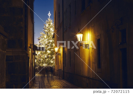 Narrow street Old Town against illuminated Christmas tree 72072115