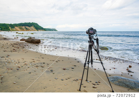 Photo camera on seashore on stormy day 72072912