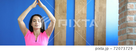 Woman in sportswear sits on boot in an asana pose. Woman in sportswear sits on boot in an asana pose. 72073729