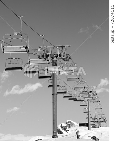 Chair-lift and snowy slope at ski resort on winter day 72074111