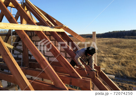 Layout and installation of roof rafters on a new commercial residential construction project by framing contractors 72074250