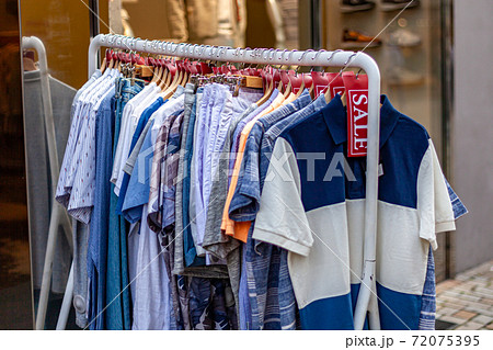 sale of clothes, stand with clothes on the straps at a discount sale of clothes, stand with clothes on the straps at a discount 72075395