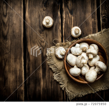 Fresh mushrooms in wooden cups. 72075950
