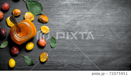 Fresh puree of ripe plums with green leaves. Fresh puree of ripe plums with green leaves. 72075951