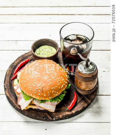 Fresh burger with cola on a wooden board. Fresh burger with cola on a wooden board. 72076038