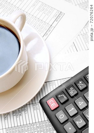 Cup from coffee, the calculator on documents. 72076264