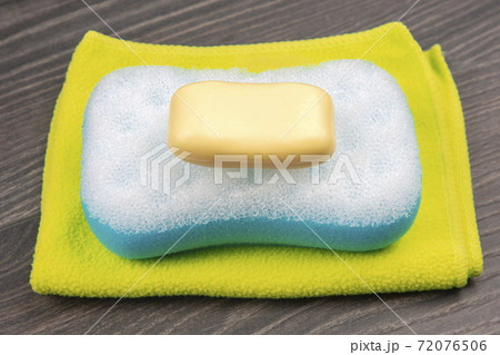 bath sponge, soap and towel on wooden background 72076506