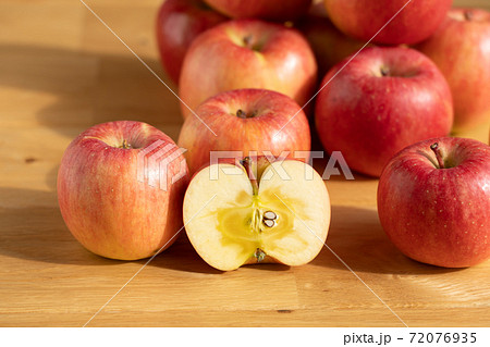 りんご　断面　フローリングに並ぶ蜜入り林檎　（11月）　こうとく 72076935