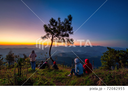 Traveller looking sunrise scene with the peak of mountain and Mist at Phu chi phe in Mae Hong Son Province,Thailand Traveller looking sunrise scene with the peak of mountain and Mist at Phu chi phe in Mae Hong Son Province,Thailand 72082955