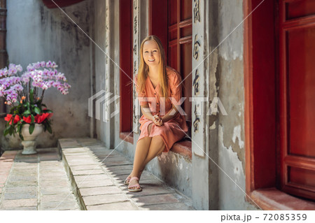 Woman tourist on background of Temple Ngoc Son in Hanoi, Vietnam.Temple of Literature is also called temple of Confucius. Vietnam reopens after coronavirus quarantine COVID 19 72085359