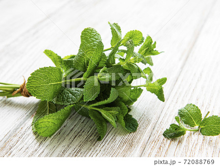 Fresh mint leaves on old wooden  background, flat lay 72088769
