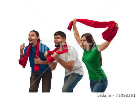 Female and male soccer fans cheering for favourite sport team with bright emotions isolated on white studio background Female and male soccer fans cheering for favourite sport team with bright emotions isolated on white studio background 72093261