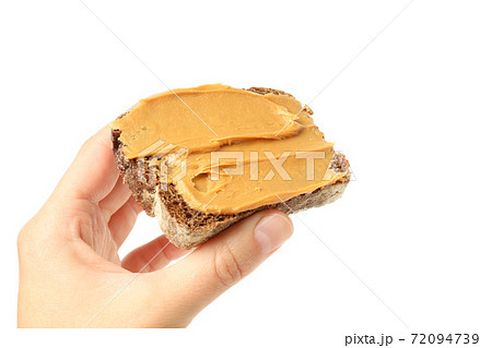 Female hand hold sandwich with peanut butter, isolated on white background Female hand hold sandwich with peanut butter, isolated on white background 72094739