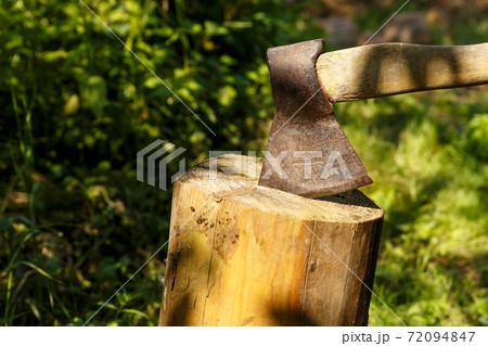 Ax stuck in the stump. Ax stuck in the stump. 72094847