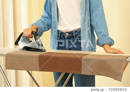 Young woman ironing Young woman ironing 72095653