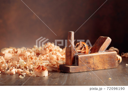 Old wooden jointer and shaving on wooden table. Old wooden jointer and shaving on wooden table. 72096190