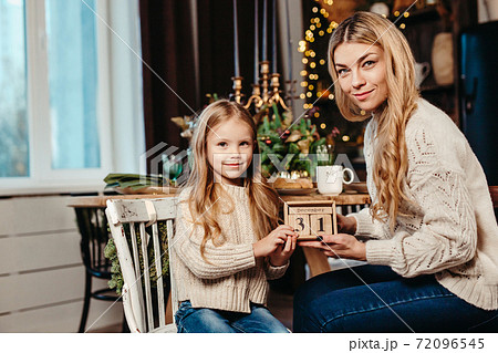 Happy family holding a wooden calendar for DEC 31 . 72096545