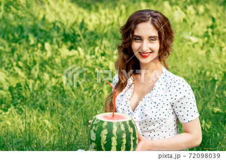 Watermelon with cocktail straw. 72098039