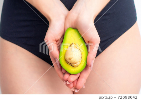 Avocado in female hands. 72098042