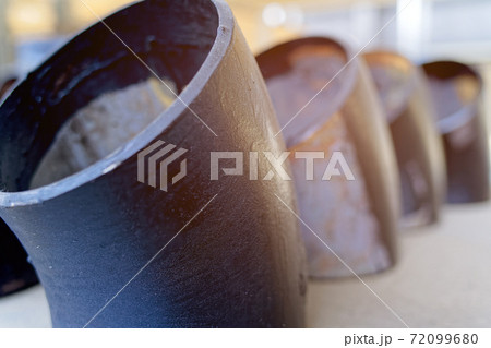 Black metal pipes and adapters of different diameters for gasification or water supply. Industrial background Black metal pipes and adapters of different diameters for gasification or water supply. Industrial background 72099680