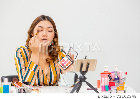 Beautiful young Asian woman making online product review at home 72102548
