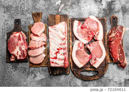 Different types of raw meat on the boards. Different types of raw meat on the boards. 72104011