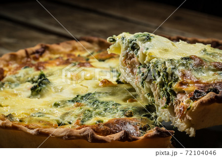 Traditional French cake. quiche with chard in white. Dark wood background. free space text. 72104046