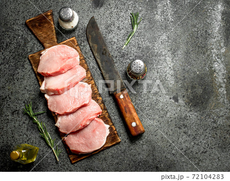 Raw pork steaks with herbs and spices. Raw pork steaks with herbs and spices. 72104283