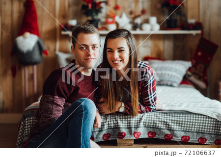 a guy and a girl celebrate the new year together. and give each other gifts 72106637