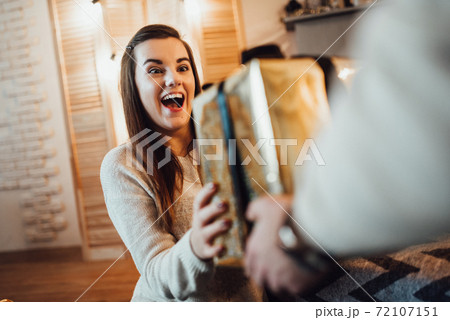 a guy and a girl celebrate the new year together. and give each other gifts 72107151