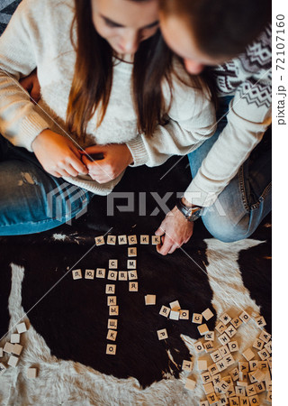 a guy and a girl celebrate the new year together. and give each other gifts 72107160