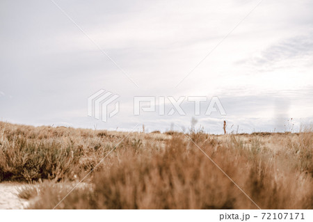 Desertic landscape and a woman Desertic landscape and a woman 72107171