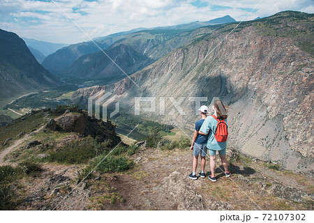 Woman an her son on the viewpoint of valley of the river of Chulyshman 72107302