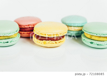 Sweet almond colorful pastel pink blue yellow green macaron or macaroon dessert cake isolated on white background. French sweet cookie. Minimal food bakery concept Copy space Sweet almond colorful pastel pink blue yellow green macaron or macaroon dessert cake isolated on white background. French sweet cookie. Minimal food bakery concept Copy space 72108085