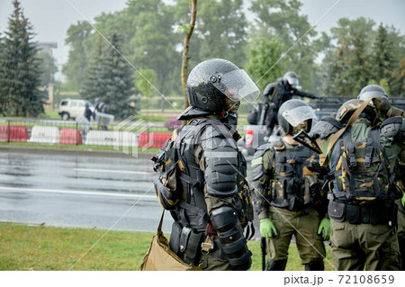 Armed police stand in the pouring rain to disperse the protesters Armed police stand in the pouring rain to disperse the protesters 72108659