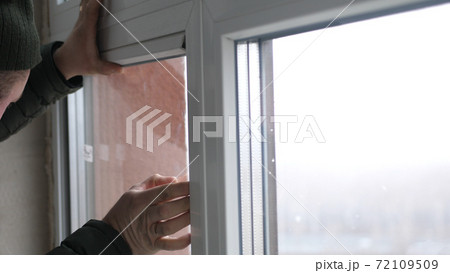 Windows installation worker, construction worker sets of plastic window. Close up of hand 72109509