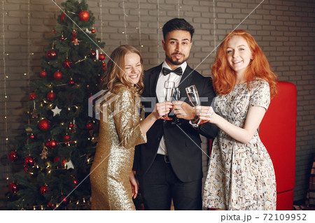 International people having fun in a decorated room 72109952
