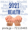 Health Happy new year greeting card 2021, health concept, text Health, greeting card 2021, woman's open palms of two hands with word HEALTH  and 2021 number above, surrounded by Health words and 72110465
