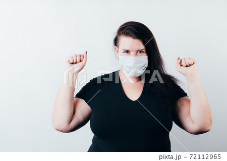 Happy joyful woman wearing a face mask Happy joyful woman wearing a face mask 72112965