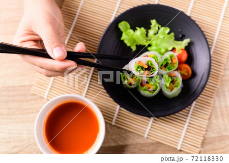 Fresh vegetables salad spring roll eating with chili sauce Fresh vegetables salad spring roll eating with chili sauce 72118330