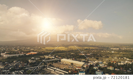 Sun shine over Mayon volcano erupt at Legazpi cityscape aerial. Philippines tourist landmark Sun shine over Mayon volcano erupt at Legazpi cityscape aerial. Philippines tourist landmark 72120181