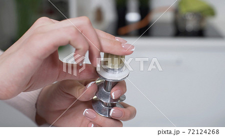 Female hands assembles meat grinder screw. Replaceable safety cap protects against mechanical overloads. Electric mincer machine for minced meat per minute. Female hands assembles meat grinder screw. Replaceable safety cap protects against mechanical overloads. Electric mincer machine for minced meat per minute. 72124268