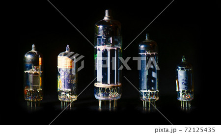 Some old used valves on a black background 72125435