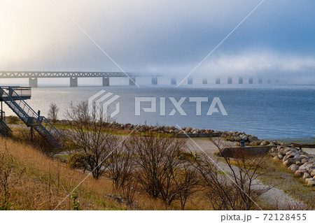 A bridge in fog. Blue ocean and mist in the background. Picture from the bridge connecting Sweden with Denmark A bridge in fog. Blue ocean and mist in the background. Picture from the bridge connecting Sweden with Denmark 72128455