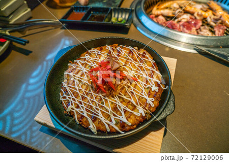 Freshly served Okonomiyaki, Japanese savory traditional pancake Freshly served Okonomiyaki, Japanese savory traditional pancake 72129006