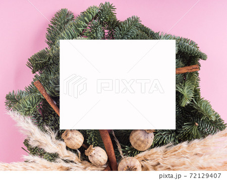 Christmas spruce wreath with white card on pink Christmas spruce wreath with white card on pink 72129407