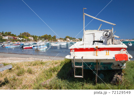 Old wooden motor boat are on the coast in port Old wooden motor boat are on the coast in port 72129549